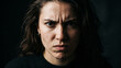 © Tegar Ramadhani - Intense closeup portrait of a woman with a furrowed brow and angry expression