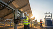 © HSR - Engineers maintaining solar panel systems on a solar farm at sunset