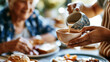 © Kateryna - A close up of European caregiver hands pours a soft hot beverage for an elderly woman during a bright breakfast at a calm nursing home in soft daylight breakfast care faceless