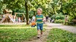© Jhon - A young boy running in a park with a toy truck playground