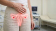 © AbdullahAl - Woman with hand on stomach showing female reproductive system with glowing red ovaries 4k