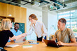 © we.bond.creations - Diverse business people collaborating in a modern office, two women making a deal with a handshake, showing teamwork and partnership