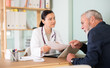 © JackF - Adult female physician sits at desk with elderly man patient, explaining test results and recommending treatment plan