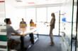 © fizkes - Businesswoman speaking to colleagues, explaining strategy, sharing business insights, giving presentation for staff members or company clients in blurred corporate office meeting, abstract background