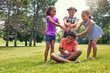 © peopleimages.com - Happy, children and water balloons in park with fun, game and bonding together for childhood memories. Kids, smile and play outdoor with splash bomb, connection and entertainment for summer holiday.