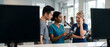 © Dinali - Diverse medical team using tablet to discuss patient care in modern hospital clinic lobby; stressed senior female doctor looking worried during collaborative discussion about diagnosis and exhaustion.