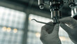 © Rachakrit - Gloved hands adjusting stainless steel dental tool on articulating arm, clinical lighting, sterile atmosphere