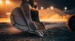 © Ng - Close-up macro shot of an excavator bucket filled with dirt at a construction site with distant lights