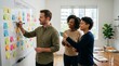 © Таня Андреева - Diverse business team collaborating on whiteboard in modern office.