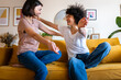 © Daniel - Happy friends greeting hugging on a yellow sofa