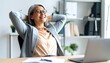 © Ros - Relaxed businesswoman at office desk
