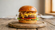 © Ibnu Fatah - Gourmet cheeseburger featuring a juicy beef patty, melted cheese, crispy onions, tomatoes, pickles, and lettuce, served on a sesame bun a top a rustic wooden board.