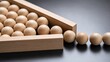 © Tanakorn - Wooden balls crowded into a narrow wooden frame illustrate concepts of bottlenecks and process optimization within a professional business workflow