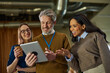 © bernardbodo - Business people collaborating on digital tablet in office