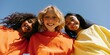© Andrii Zastrozhnov - Smiling trio of children in colorful shirts under blue sky for friendship banner background and youth campaign design