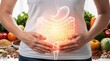 © PengAI - A person holds their stomach with a glowing digestive system overlay, surrounded by various healthy foods like vegetables and grains.