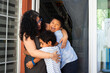 © Arianne - Mother embracing her two happy sons at home