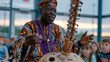 © Maksym - West African griot elder in formal ceremonial attire holds a kora instrument in his lap while narrating to seated children in a community hall, hand gestures animated mid-story, a quietly dramatic o