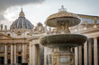 © 9parusnikov - Fountain in Saint Peters Square with the Vatican Basilica dome