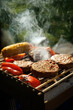 © 9parusnikov - Close Up of Vegan Burgers Sizzling on Portable Charcoal BBQ