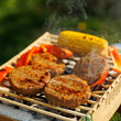 © 9parusnikov - Vertical Shot of Vegan Burgers Grilling Outdoors with Smoke