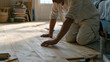 © forenna - back-to-school prep scene of a parent laying new hardwood flooring in a child's bedroom while school supplies sit stacked in the corner, end-of-summer renovation urgency, warm indoor light, family h