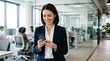 © Alina Sukach - A smiling businesswoman holding a smartphone in an office, checking mobile work updates, clean corporate background with copy space, tailored attire, crisp natural light and efficient modern mood,