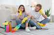 © New Africa - Spring cleaning. Tired couple with detergents sitting on floor at home