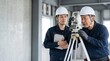 © 望見 柿元 - 建設現場で測量機器を使用しOJT教育を行う2人の現場監督の作業風景