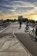 © Angela to Roxel/imageBROKER - Pedestrians and cyclists on bridge over Inner Harbour, Lille Langebro cycle bridge, road safety, modern mobility, architects WilkinsonEyre and BuroHappold, backlight, sunset, city centre, Copenhagen, Denmark