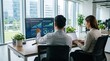 © Alex - Colleagues reviewing ESG sustainable fund performance on large monitor in bright office, green energy investment analysis