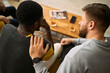 © DragonImages - Young adult men supporting friend during group conversation, showing trust, empathy, male friendship. Useful for mental health, peer support, counseling, community campaigns