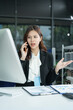 © NINENII - Businesswoman talking on the phone arguing laptop computer problems highlighting customer dissatisfaction.