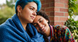 © Inspire Shots Hub - Close-up of two people embracing, one with blue hair and a blue blanket, the other resting her head, symbolizing affection, connection, and intimacy.