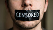 © Cliff - Close-up of tape on a human mouth with the word Censored, symbolizing the suppression of speech, silence, and social ostracism associated with mental health struggles and the advocacy for free speech