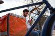 © Oscar - Delivery courier checking smartphone for next order