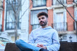 © Oscar - Young man with beard relaxing on urban bench