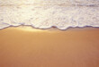 © Tetra Images - Close-up of sea wave washing sandy beach