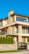© Senja - Luxurious Modern Home with Stone Facade and Black Gate Under Clear Blue Sky.