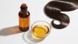© Stunning stock - Natural hair oil treatment in amber glass bottle and bowl, shiny brunette hair lock on white background, organic beauty serum for hair care