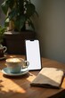 © Leonardo - Mesa de café, teléfono inteligente apoyado contra una taza de café, pantalla en blanco, superficie de madera rústica