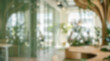 © Celt Studio - abstract out of focus blurred green eco office workspace interior eco-friendly sustainable corporate design glass walls tropical plants background