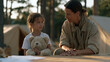© forenna - Nervous seven-year-old clutching a stuffed bear at a lakeside summer camp registration table, counselor kneeling to eye level in warm morning light, pine trees and canvas tents behind them, first-da