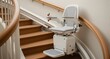 © Konstantin - Curved staircase stair lift rental setup showing the fitting process in clear detail focusing on the lift chair and rail background softly blurred.