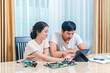 © SpaceOak - Asian Couple Working Together on Computer Circuit Board Repair and Electronics at Home