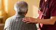 © Mamer - A compassionate healthcare worker offers support and comfort to an elderly patient, gently placing a hand on their shoulder in a moment of empathetic connection and profound care