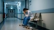© Ghulam - Doctor sits exhausted in a sterile hospital hallway surrounded by discarded coffee cups after a long shift to illustrate workplace burnout and the heavy emotional burden carried by medical workers.