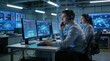 © JohnLee - Professional IT Technical Support Specialist and Software Developer Working on Computer in Monitoring Control Room with Digital Screens. Employee Wears Headphones with Mic and Talking on a Call.