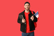 © Pixel-Shot - Male student with flag of France on red background