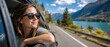 © Vasiliy - Smiling woman looking out of a car window on a scenic road trip. Female traveler enjoying the view of a turquoise lake and mountains. Summer vacation and travel concept
